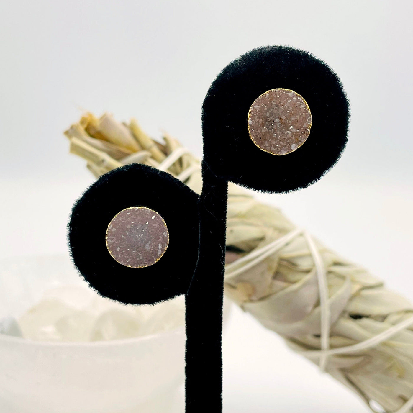 close up of one pair of gold natural druzy round stud earrings on display