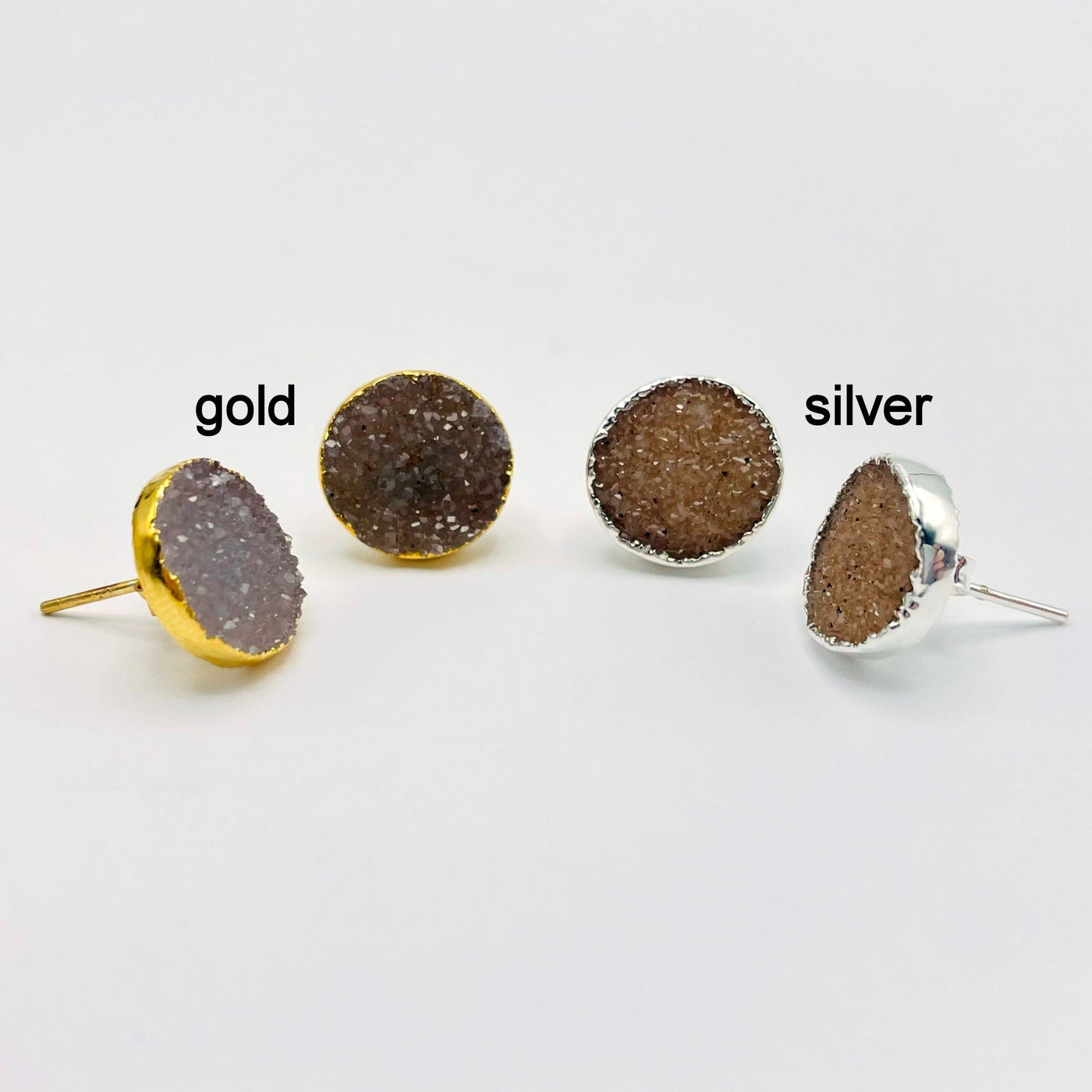 one pair of gold and one pair of silver natural druzy round stud earrings on white background for finish comparison