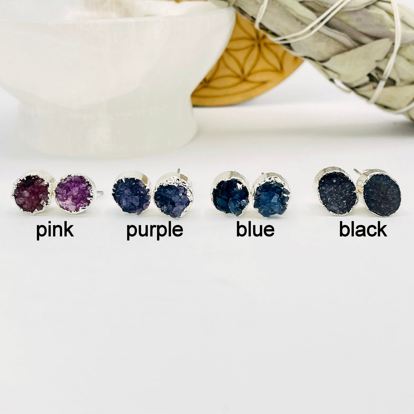 one of each round druzy stud earring color options on display for color comparison