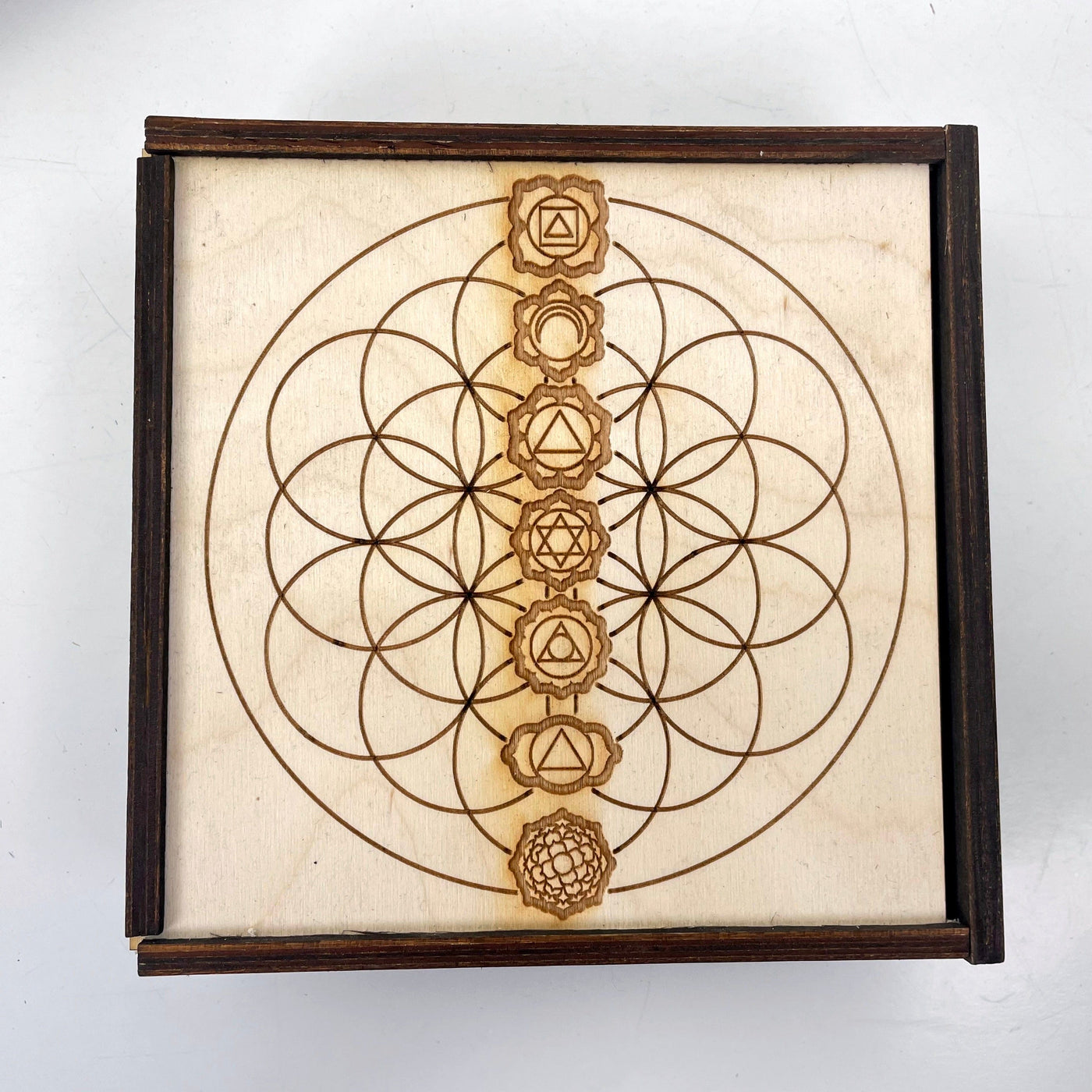 close up of flower of life with seven chakra engraving 