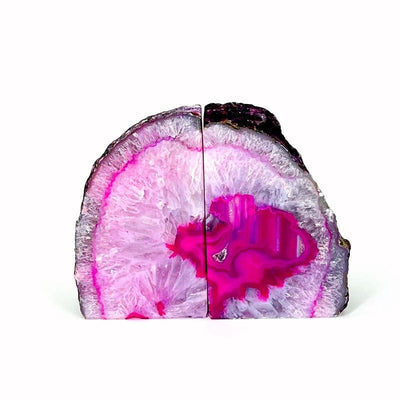 Frontal view of Pink Agate Geode Bookend Pair pictured on a white surface.