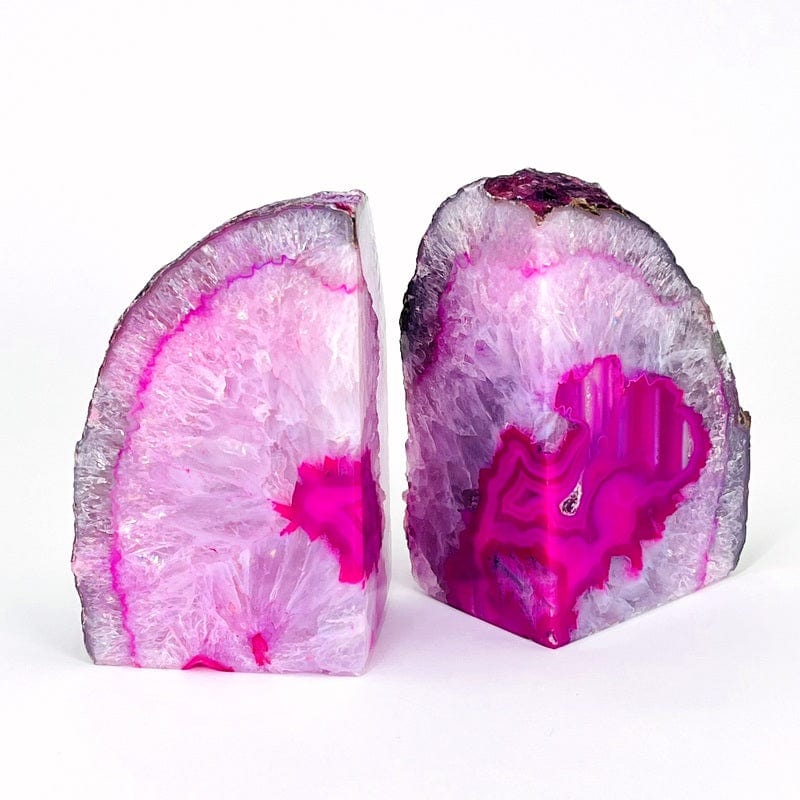 Angled view of Pink Agate Geode Bookend Pair on a white surface.