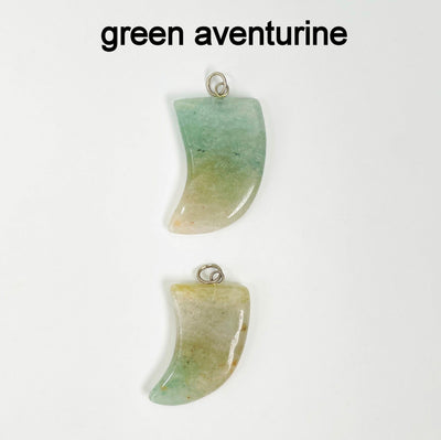 close up of two tumbled green aventurine horn pendants on white background for details and possible variations