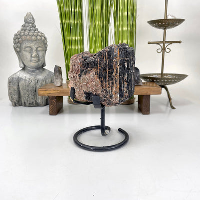 black tourmaline on stand in front of backdrop
