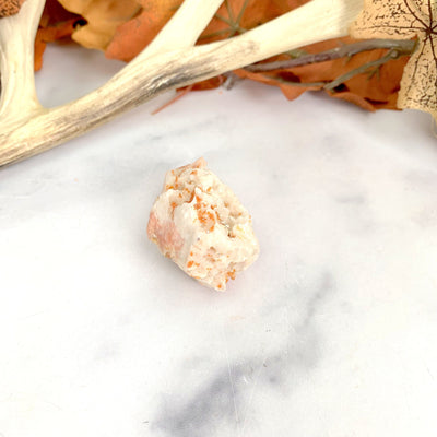 side view of vanadinite cluster with a white marble background