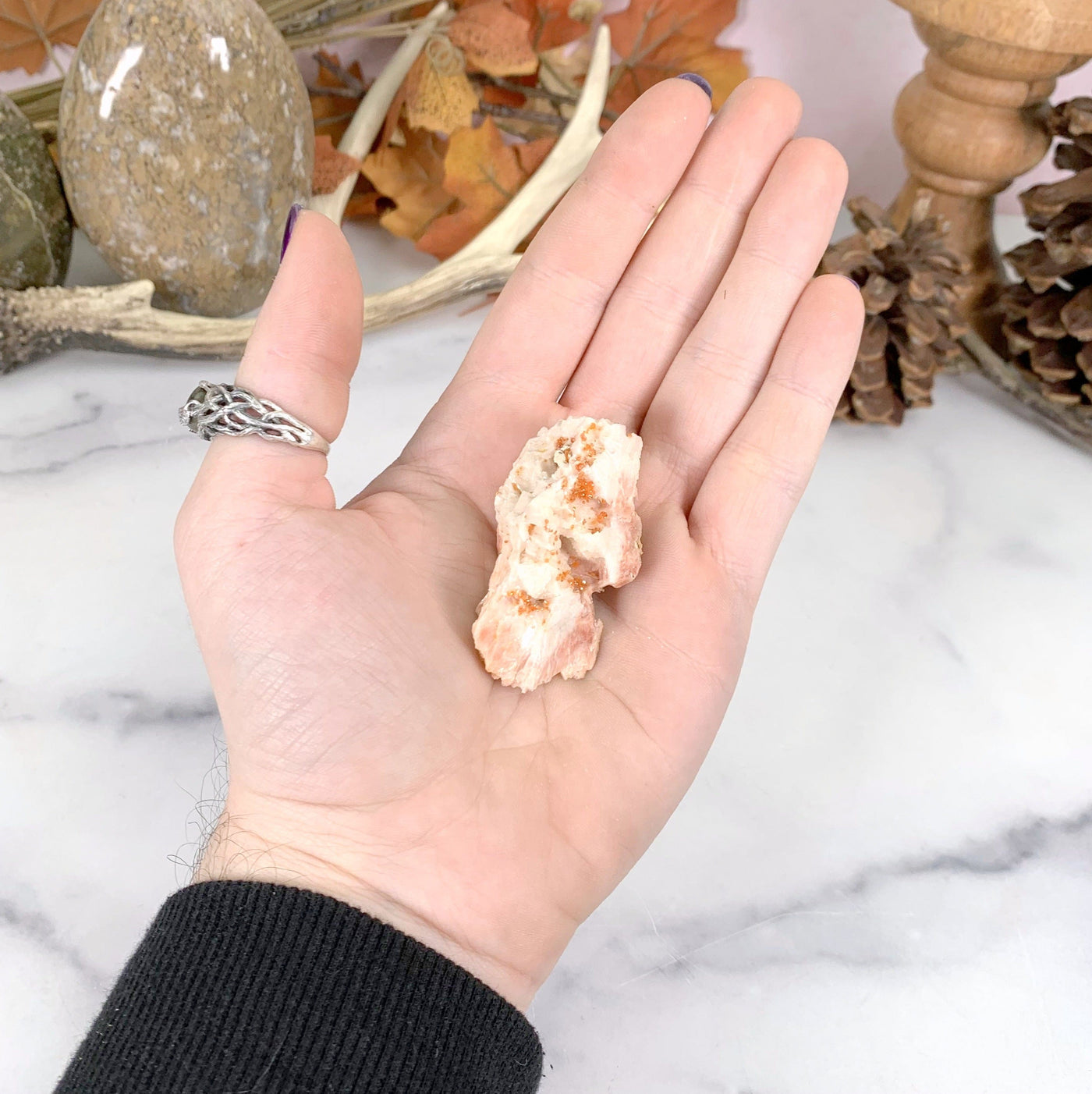 vanadinite cluster bottom view in hand with white marble background