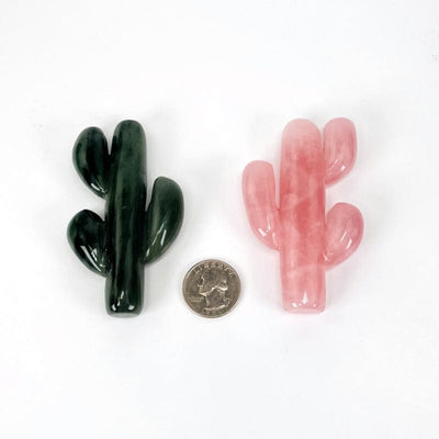 close up of the crystal cactus next to a quarter for size reference 