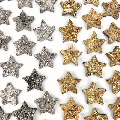 silver and gold titanium stars on a white background