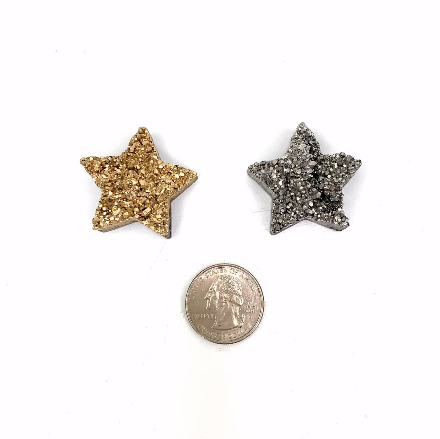 a silver and a gold star on a white background compared to a quarter stars are slightly larger than the quarter