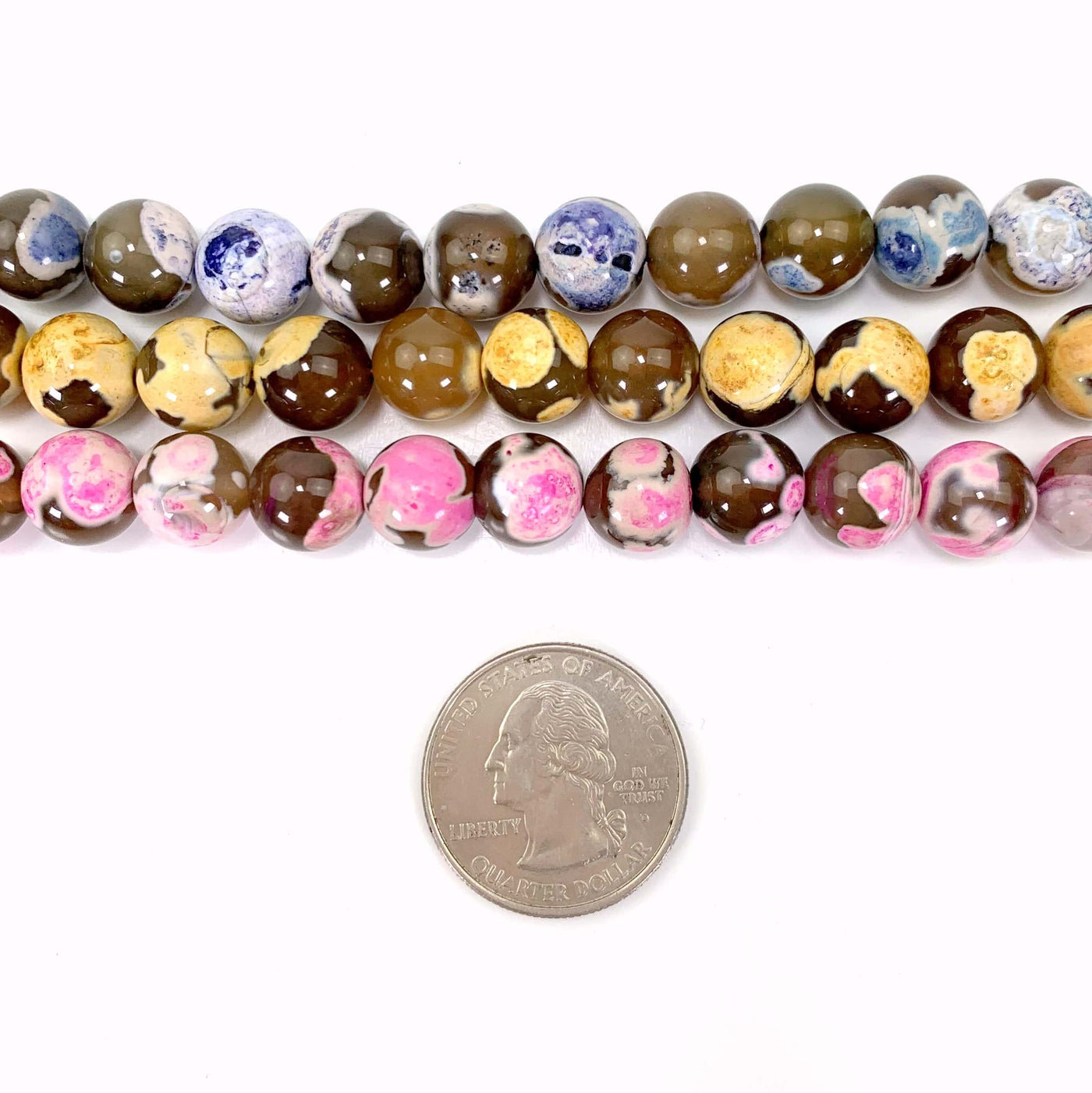 all 3 variations of dyed agate beads on a white background with a quarter next to them