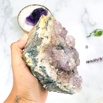 Hand holding the side angle of Option D - Amethyst Cluster Candle Holder