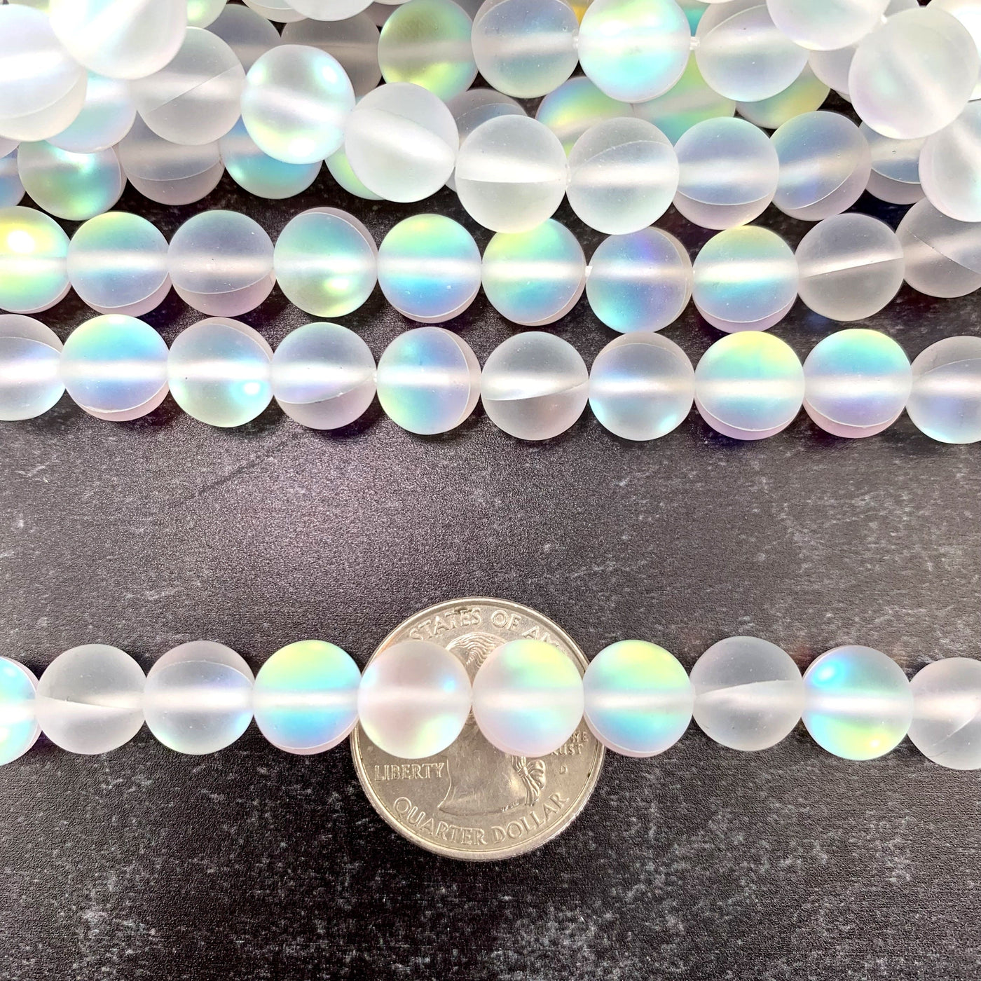 Opalite Polished Beads - strand across a quarter