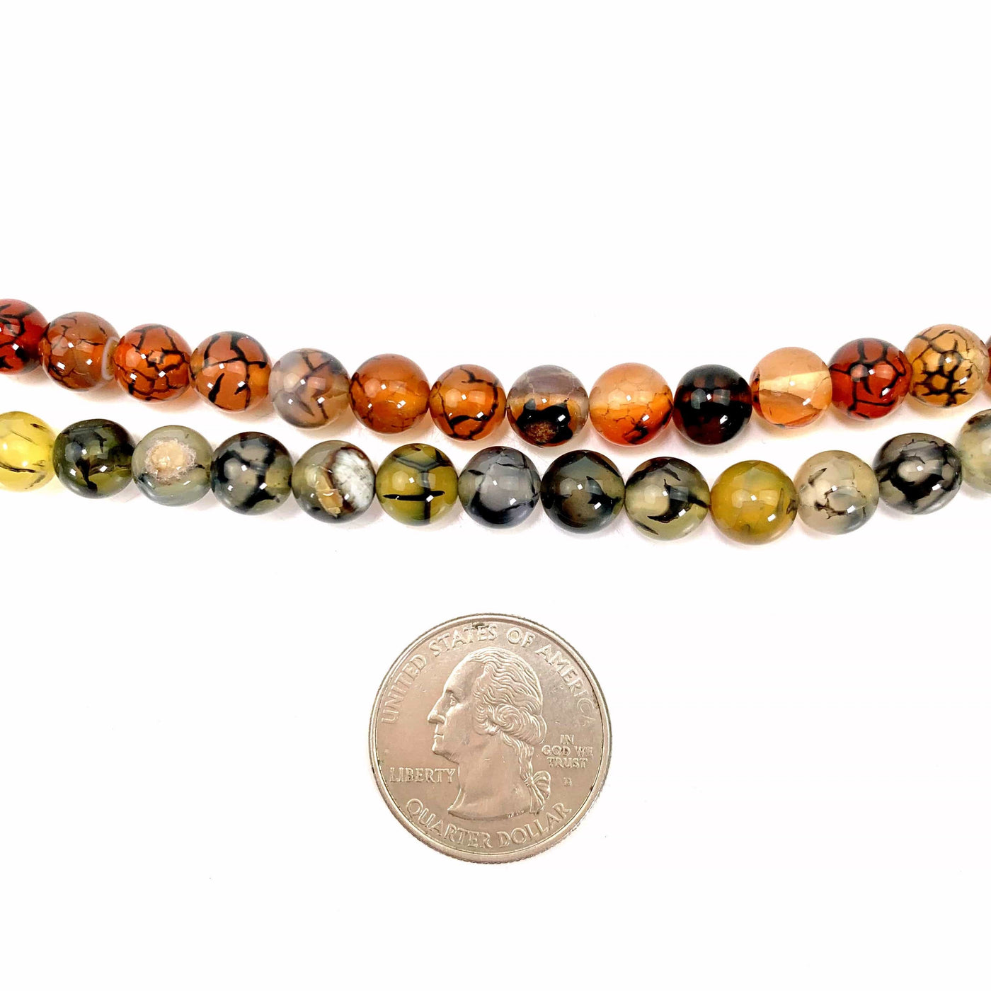 both variations of beads on a white background with a quarter next to them