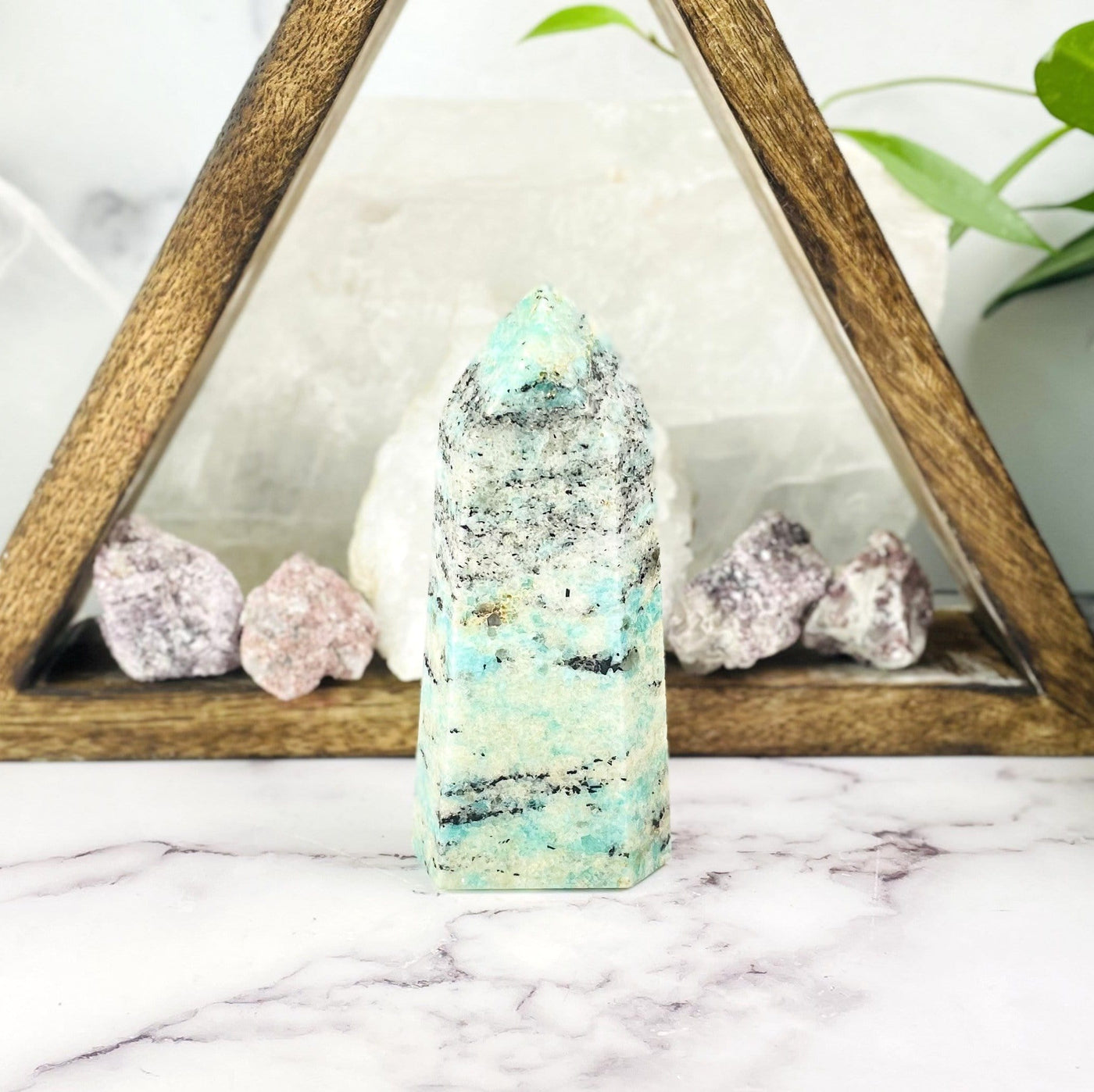 amazonite point standing for display.