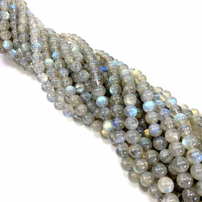 labradorite beads twisted together on a white background