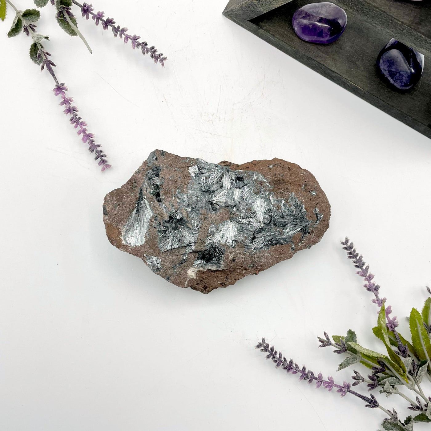 overhead view of raw stibnite on matrix laying flat with backdrop