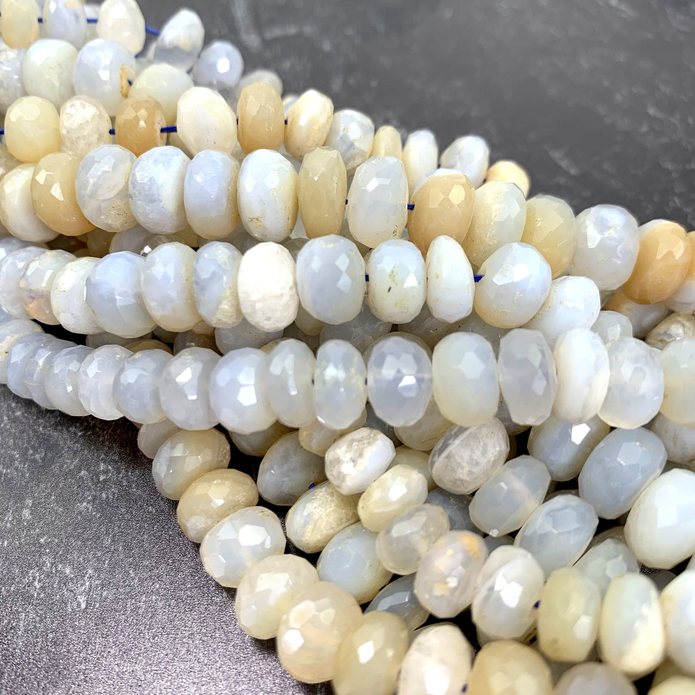 faceted round chalcedony beads twisted together on a black background