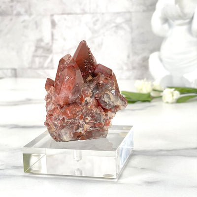 A side angle of the Red hematite Quartz on acrylic stand