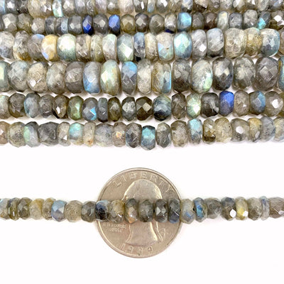 FACETED ROUND LABRADORITE BEADS on a quarter with a white background