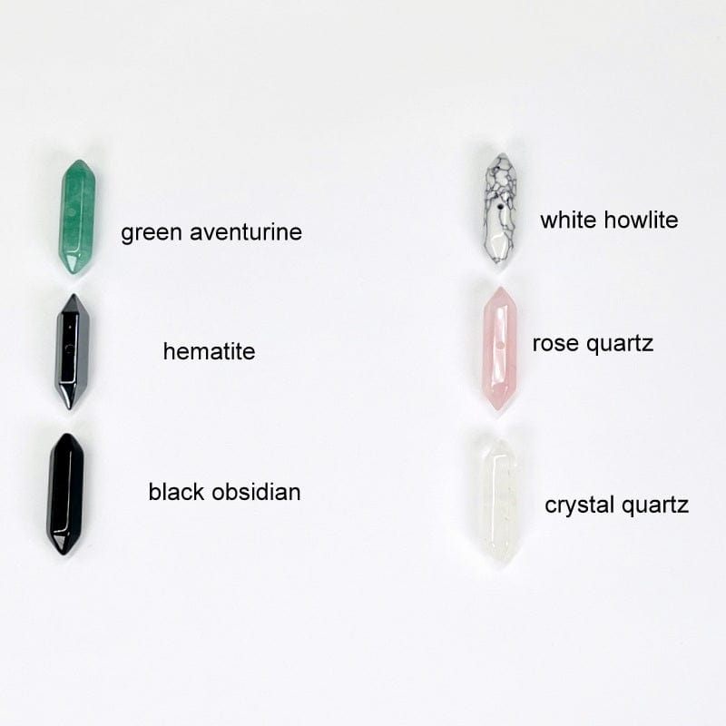 double terminated pencil point beads with a center drill hole next to their stone name. available in green aventurine, hematite, black obsidian, white howlite, rose quartz, and crystal quartz 