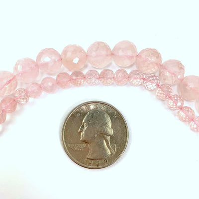 both variations of rose quartz ( top large, bottom small) on a white background next to a quarter