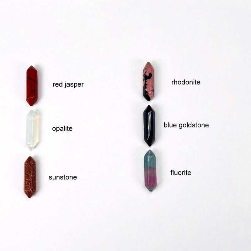 double terminated pencil points next to their stone name. available in red jasper, opalite, sunstone, rhodonite, blue goldstone, and fluorite