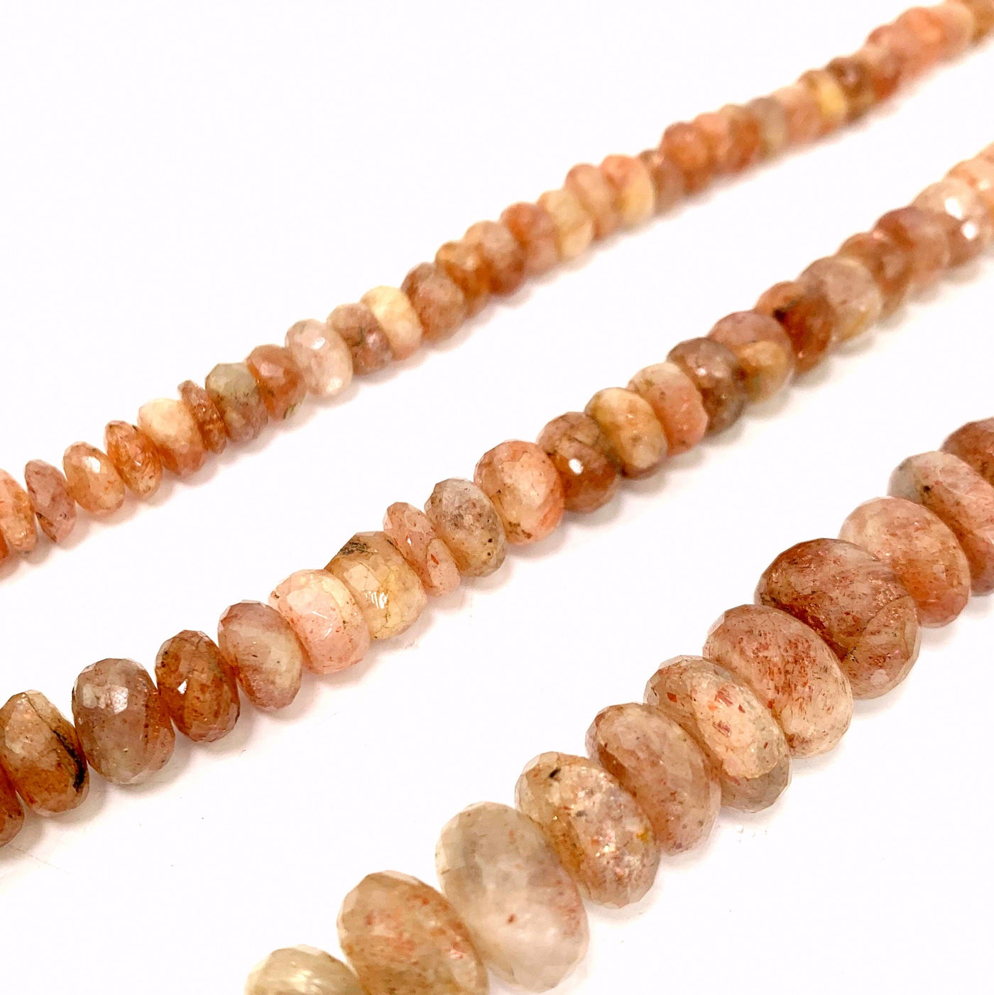 all 3 variations of sunstone faceted beads ( top small, middle medium, bottom Large) on a white background