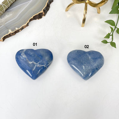 both blue calcite heart options laying flat in front of backdrop