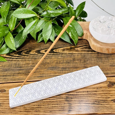 selenite bar with engraved flower of life grid displayed as home decor 