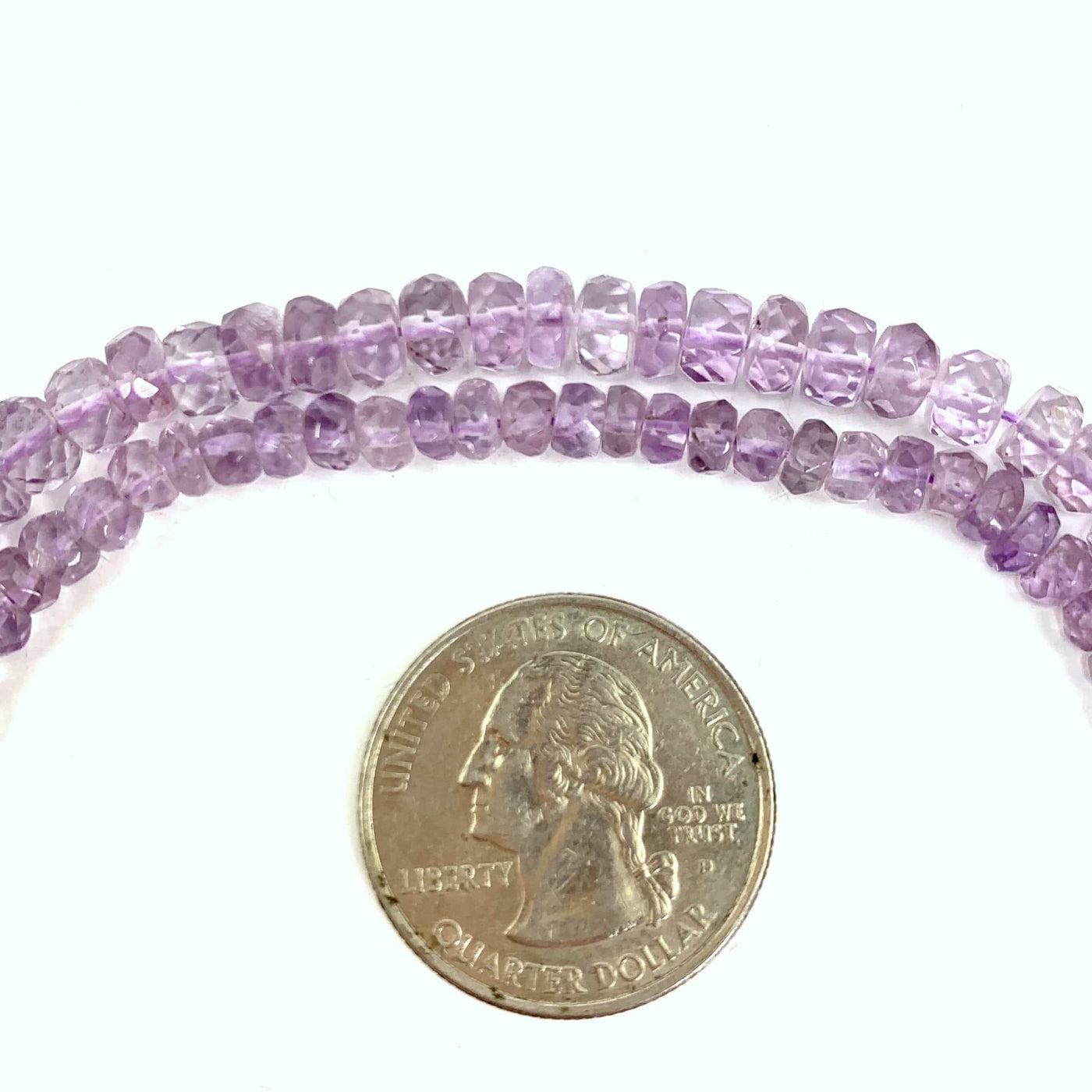 both amethyst beads ( top large, bottom small) next to a quarter on a white background