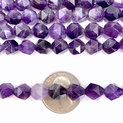 amethyst beads over a quarter with more beads in the background with a white backdrop