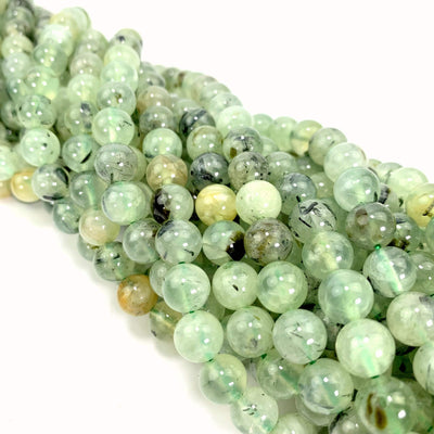 prehnite beads twisted together on a white background