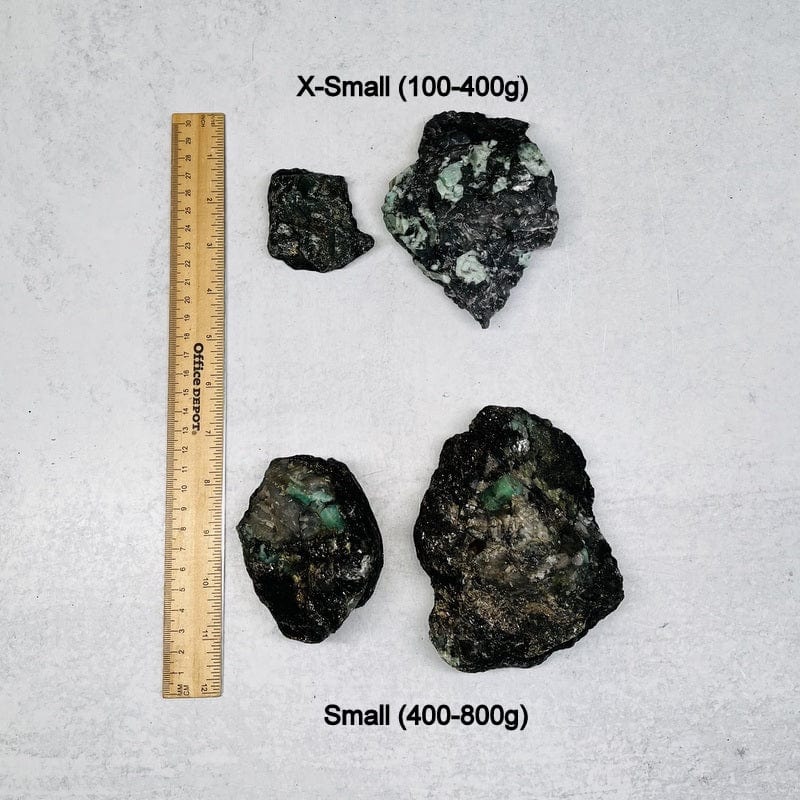 raw emerald clusters next to a ruler for size reference. displayed is the extra small and small option 