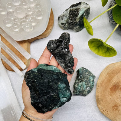 smaller emerald clusters in hand for size reference 
