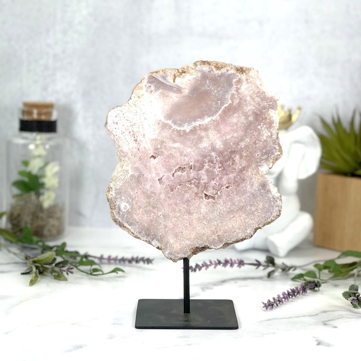 A front side of Pink Amethyst on metal stand