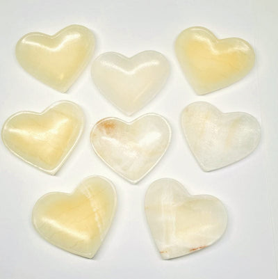 multiple light onyx heart bowls displayed to show the differences in the colors