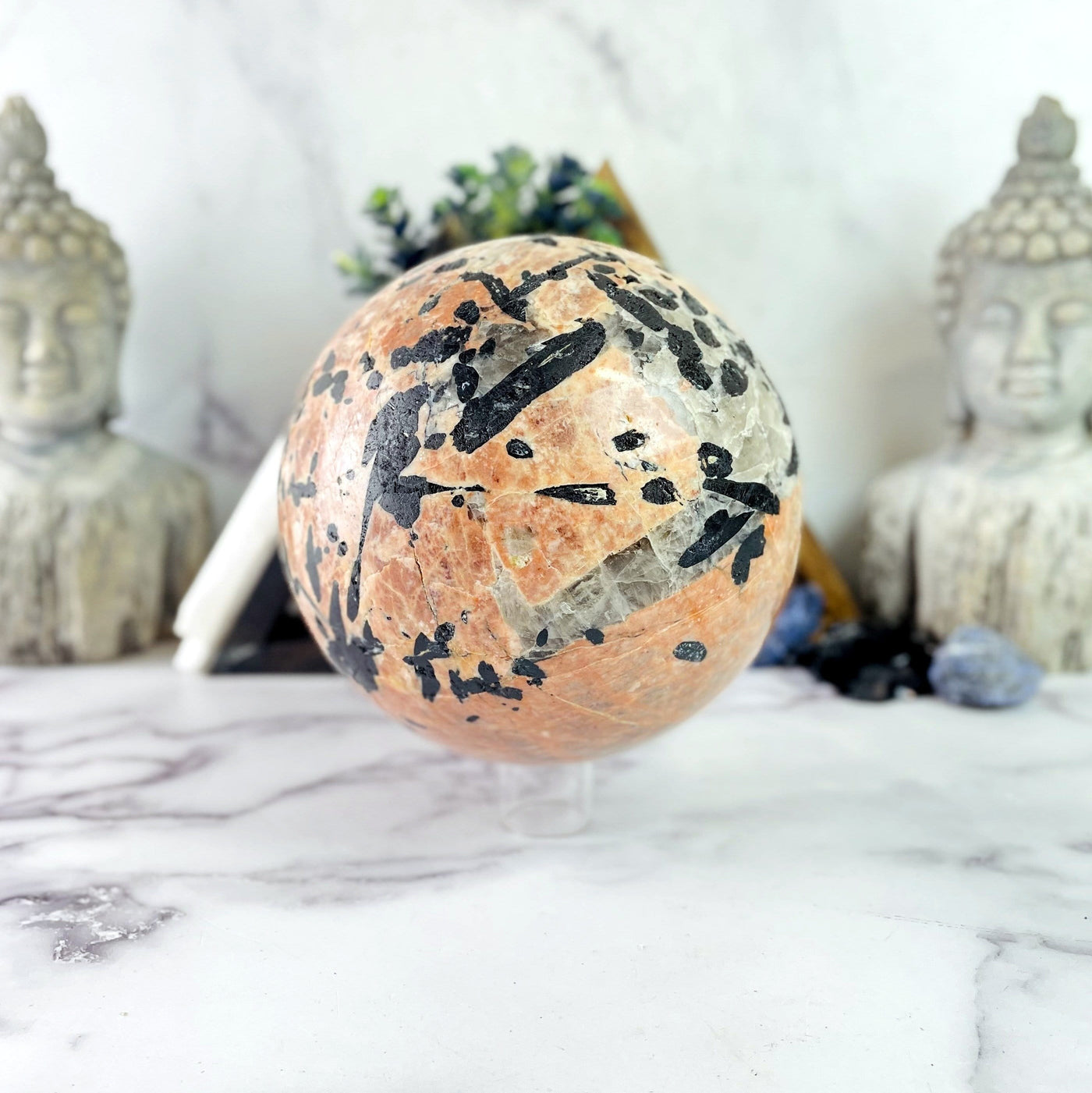 Black Tourmaline with Feldspar sphere with decorations in the background