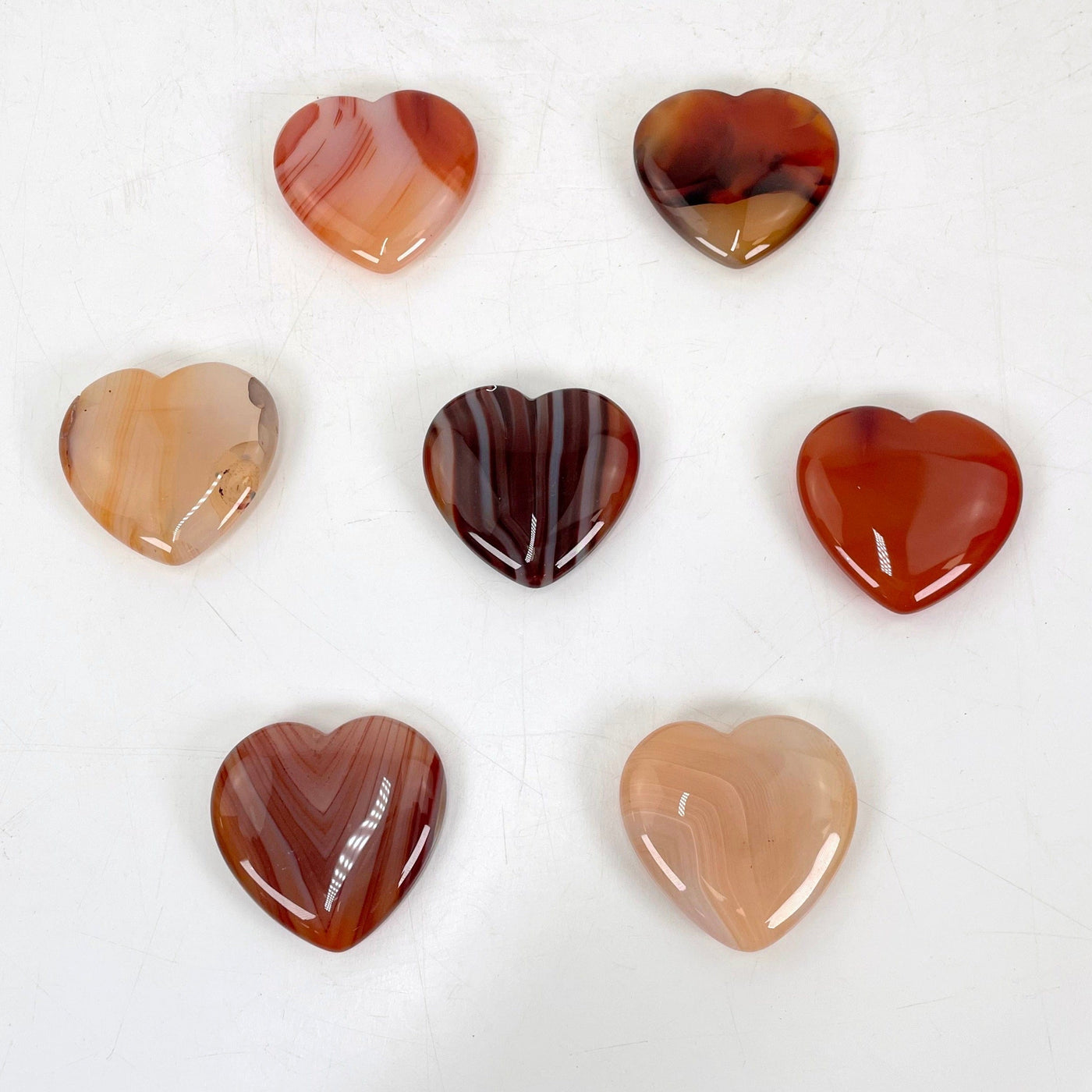 carnelian polished hearts laying flat for possible details