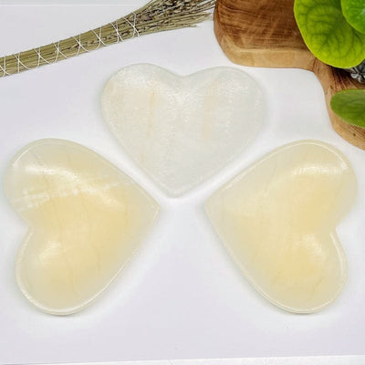 multiple light onyx heart bowls displayed to show the differences in the color shades 