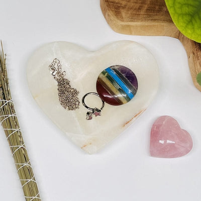 light onyx heart bowl being used as a jewelry holder 