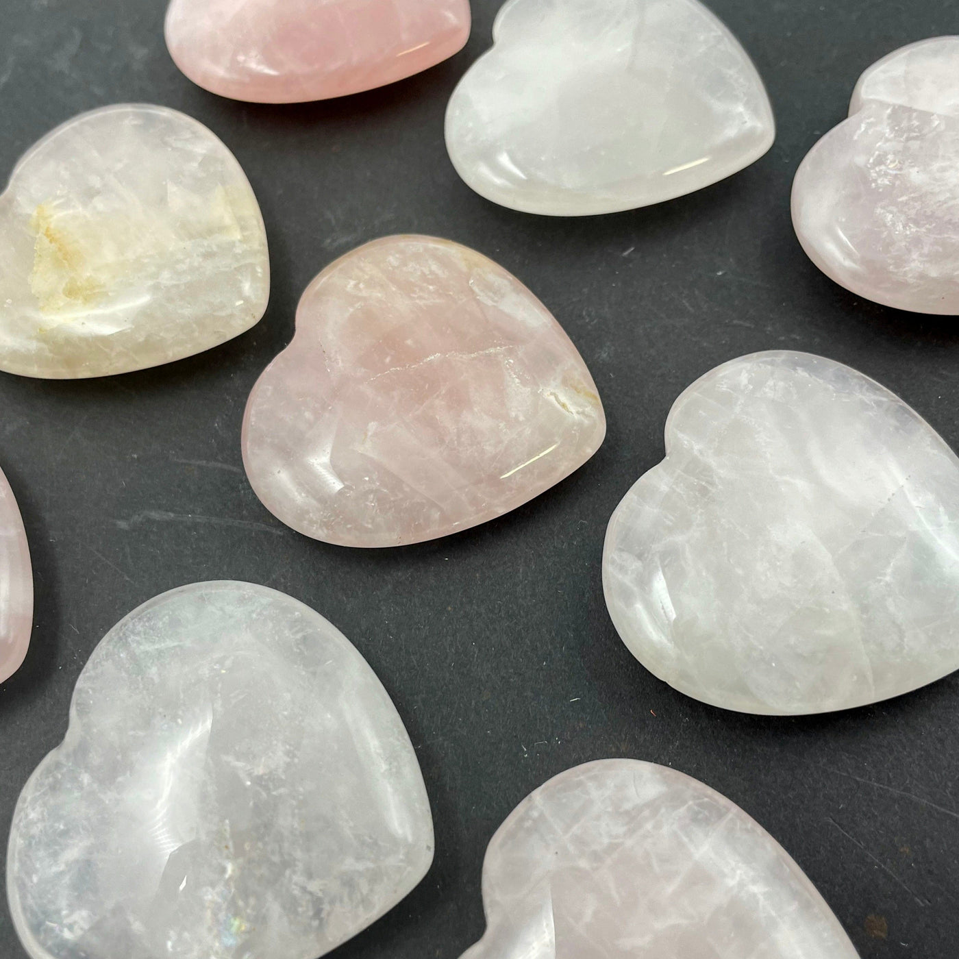 angled view of rose quartz polished hearts for thickness