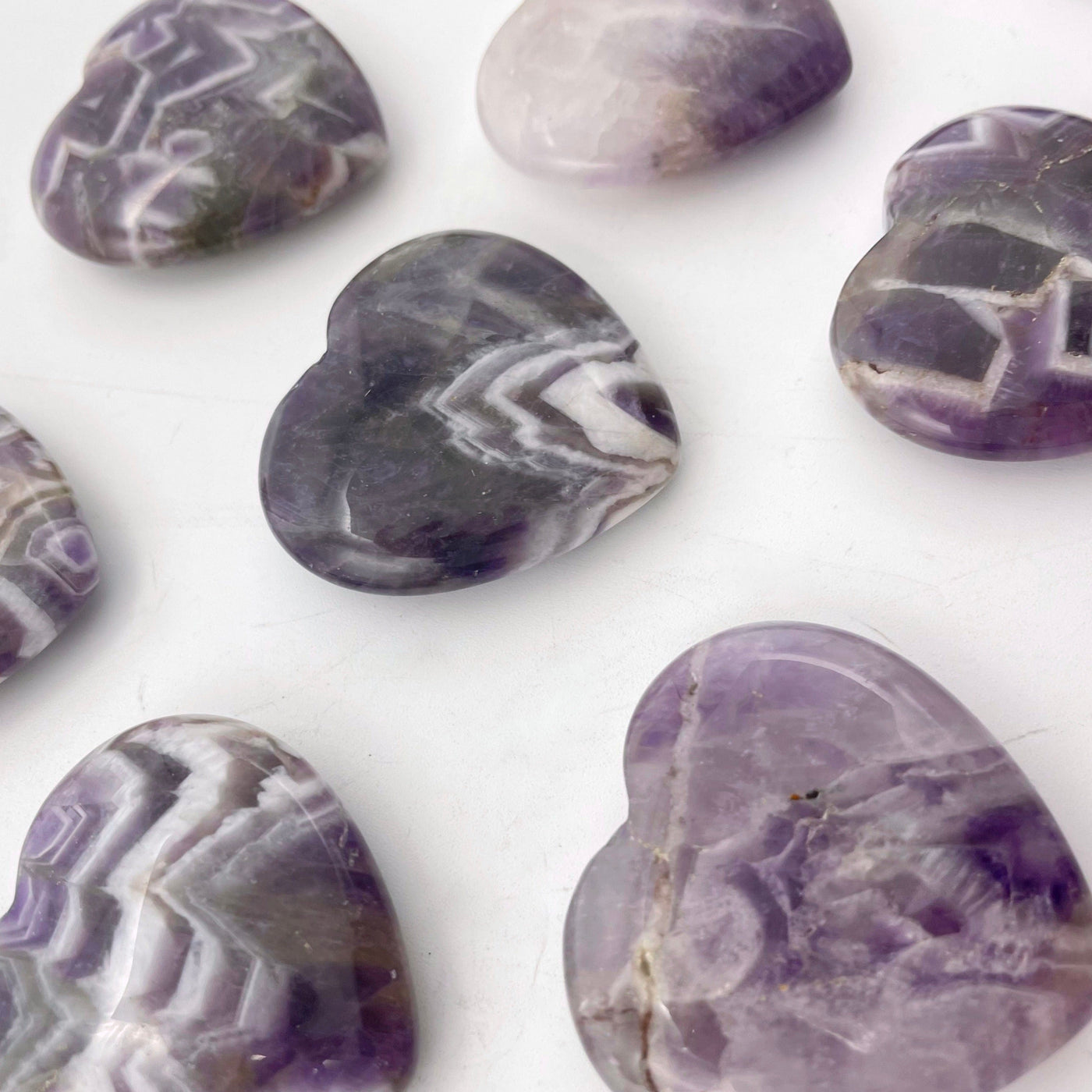 angled view of chevron amethyst polished hearts for thickness