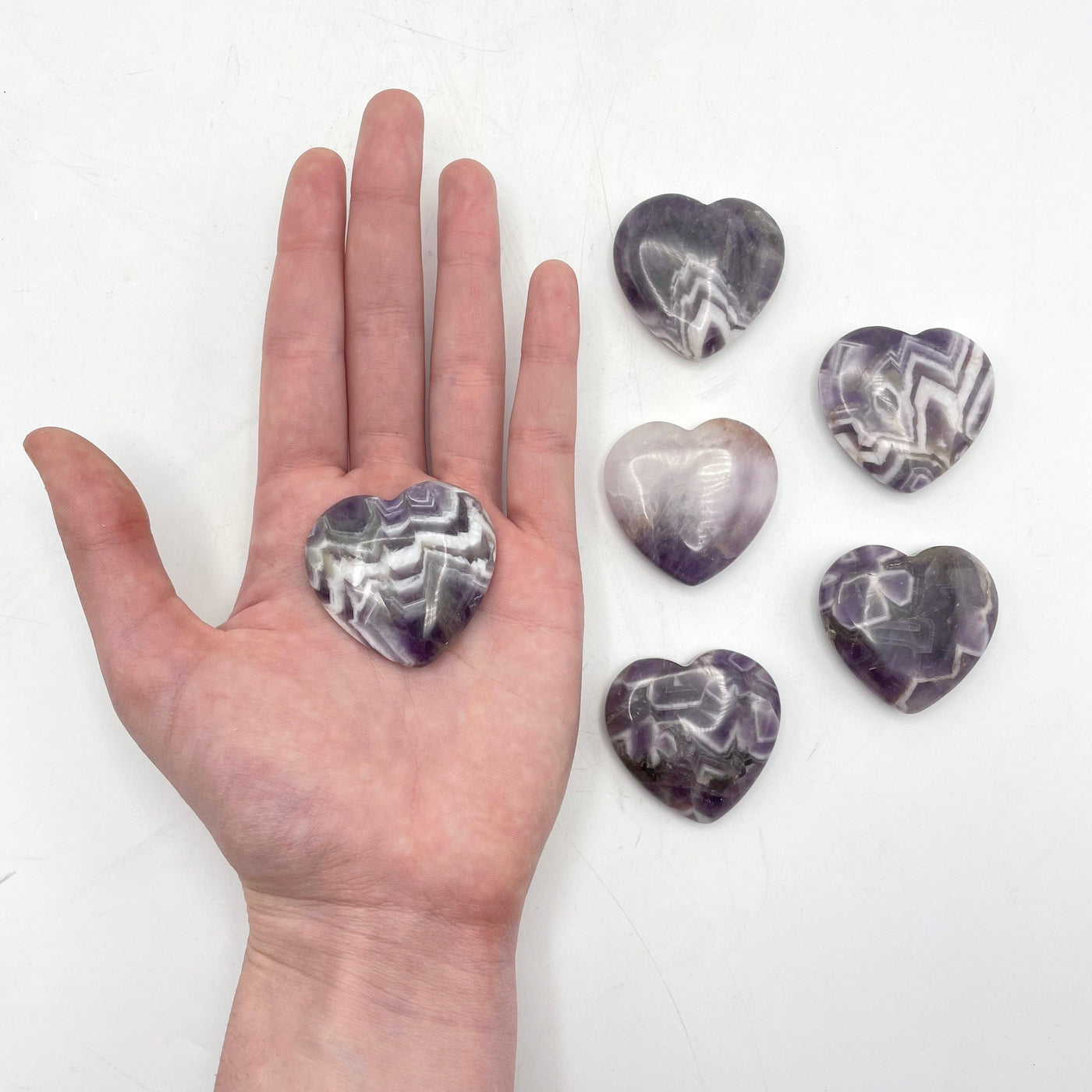 one chevron amethyst polished heart in hand for size reference