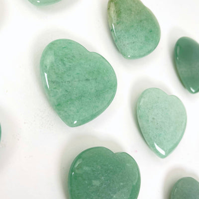 angled view of green aventurine polished hearts for thickness