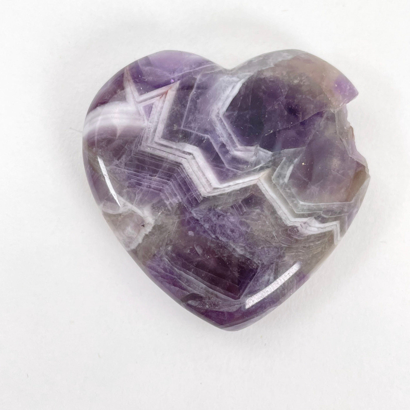 close up of chipped amethyst polished heart for possible damages
