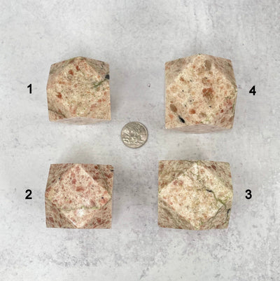 four sunstone icosahedrons around a quarter showing difference is size and designs
