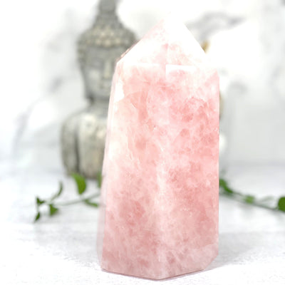 A close up of the Rose Quartz Polished Tower on white background