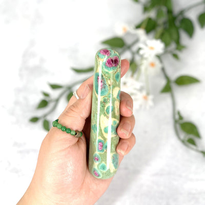 Hand holding up close the Ruby Fuchsite massage wand