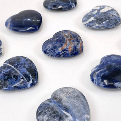angled view of sodalite polished hearts for thickness