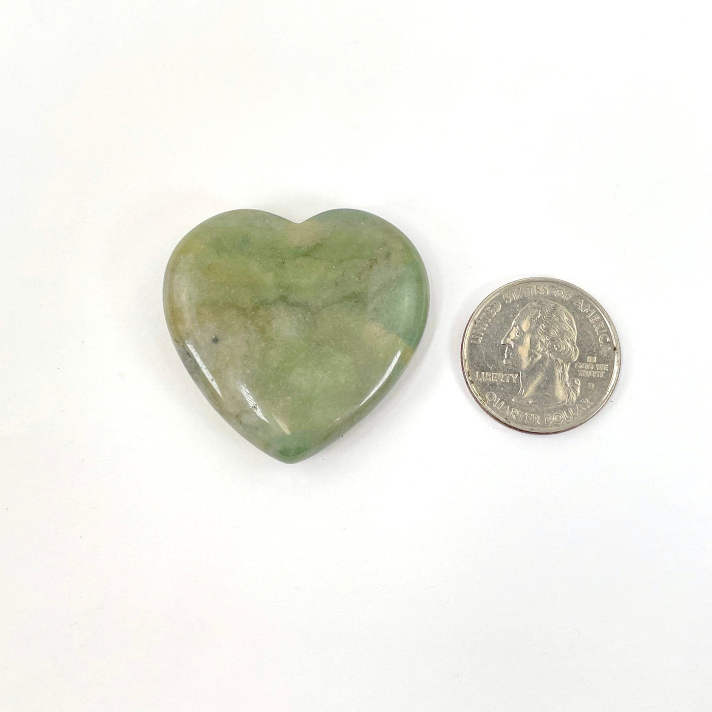 close up of moss agate polished heart with quarter